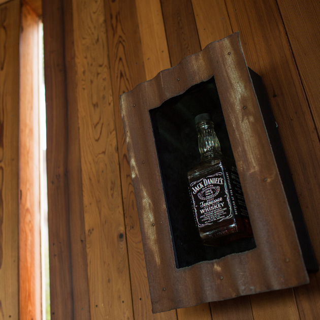 Historic photo of the bottle of Jack Daniels that sealed the partnership to convert Post Ranch into an inn