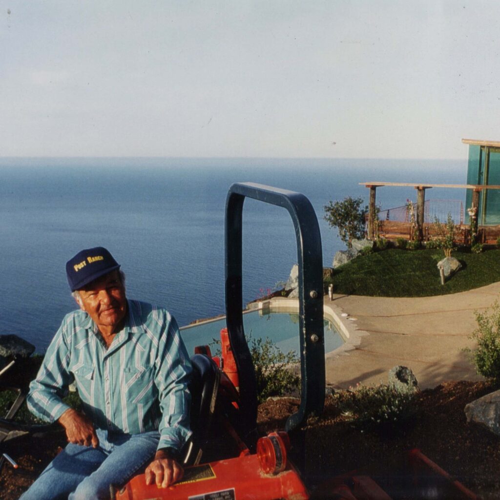 Historic photo of Billy Post on tractor, excavating Post Ranch for the inn